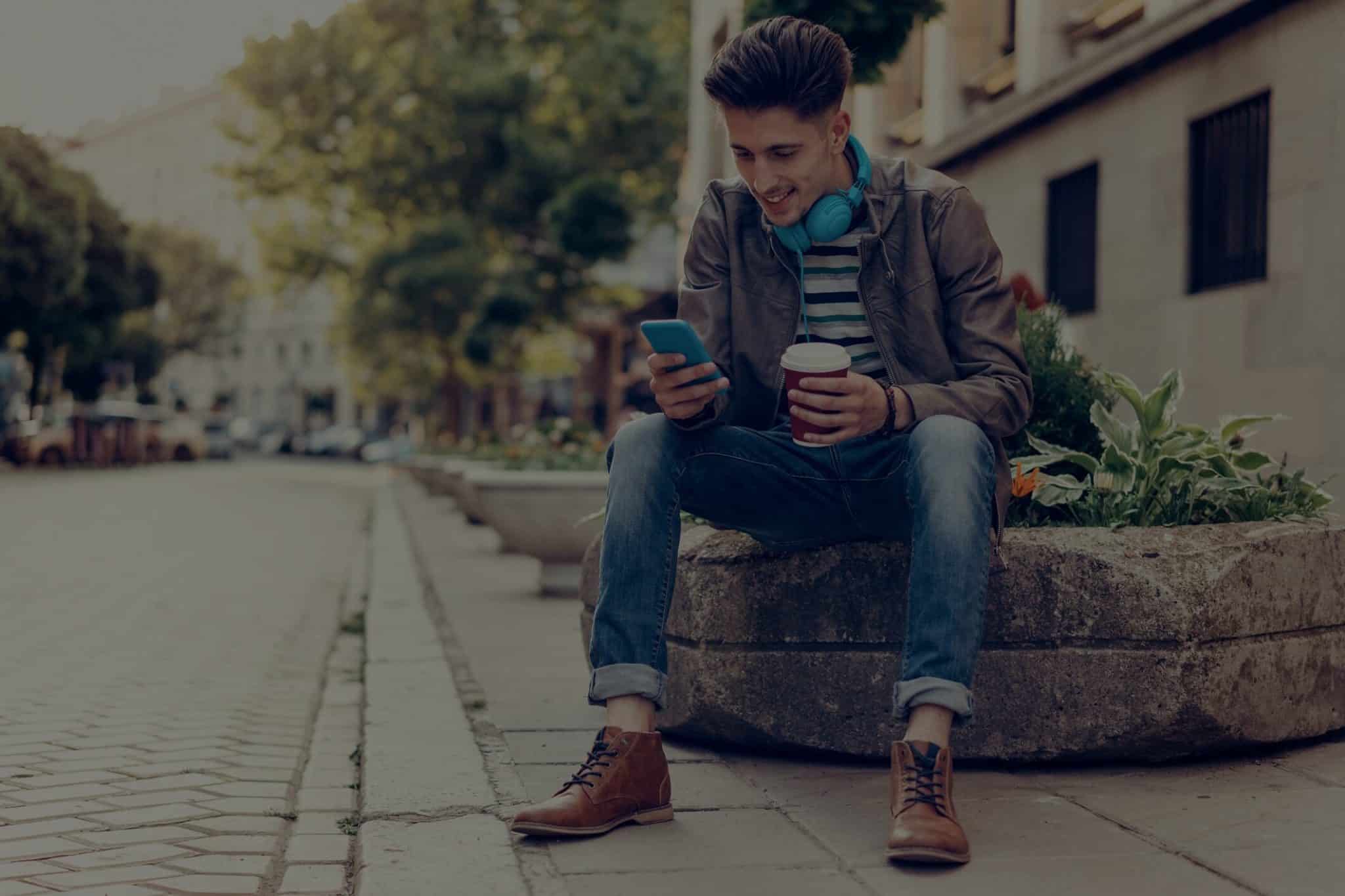 man doing refinance auto loan on mobile phone