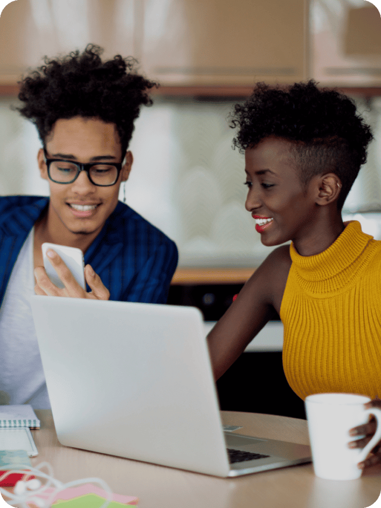 man and woman shopping for new auto loans on a laptop