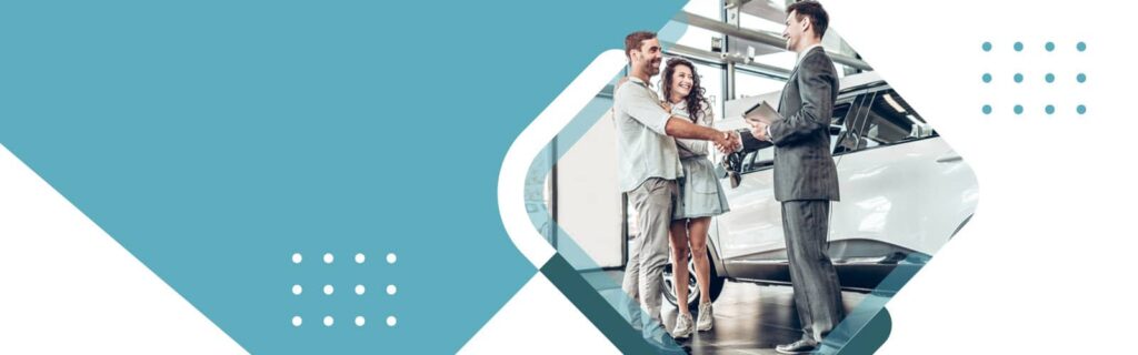 couple shaking hands with a car salesman