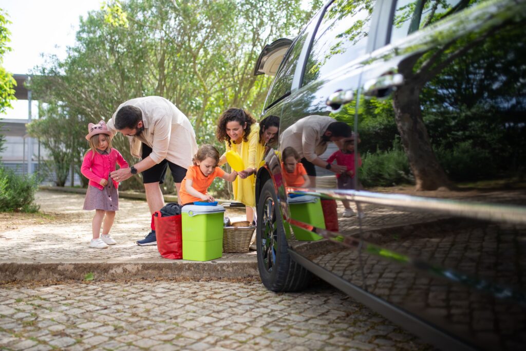 Family getting things out of car trunk.