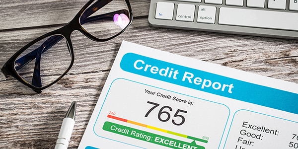 credit score report with reading glasses