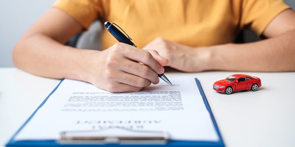 woman hand signing contract